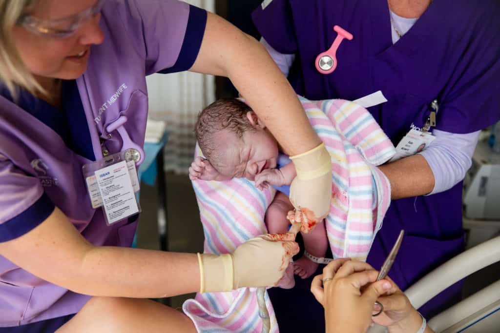 Newcastle birth photographer Angela Hardy captures cutting the umbilical cord of baby Marcus