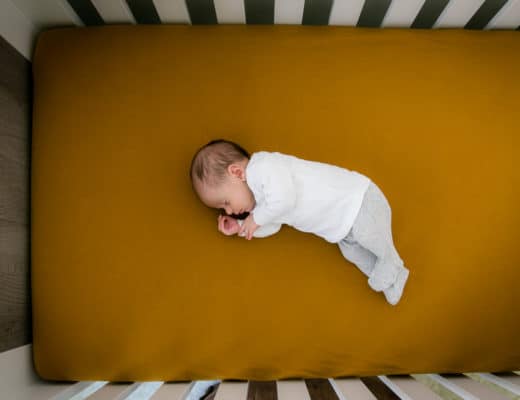 Newborn baby sleeping is his crib