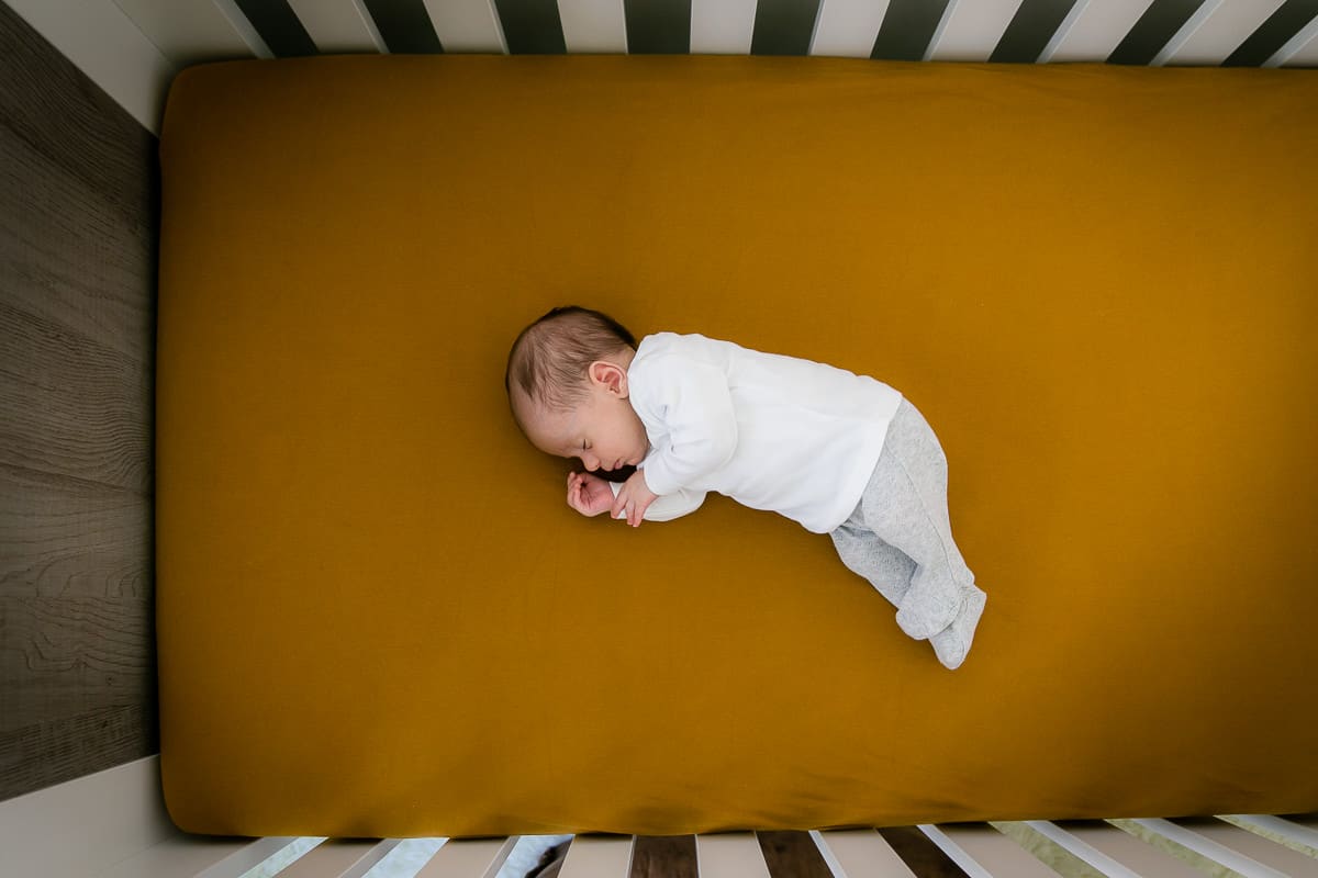 Newborn baby sleeping is his crib