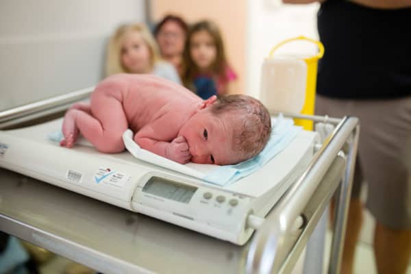 Baby being weighed after birth